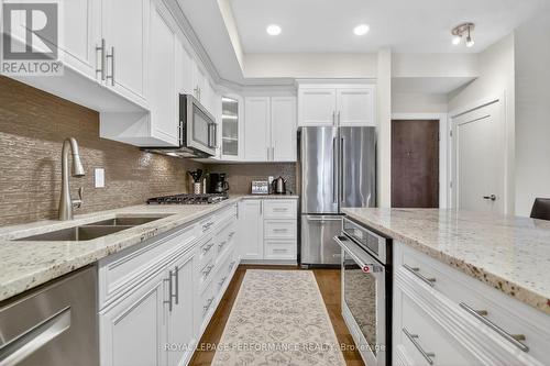Granite counters, note the built in oven - 408 - 615 Longfields Drive, Ottawa, ON - Indoor Photo Showing Kitchen With Stainless Steel Kitchen With Double Sink With Upgraded Kitchen
