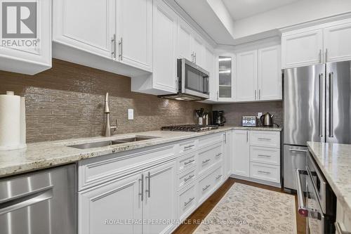 Glass ceramic bachsplash, lots of dawer storage. - 408 - 615 Longfields Drive, Ottawa, ON - Indoor Photo Showing Kitchen With Stainless Steel Kitchen With Upgraded Kitchen