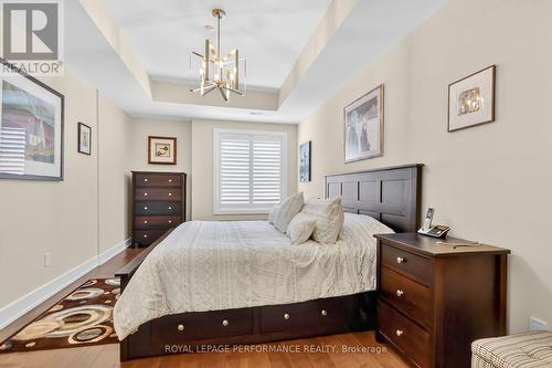 Custom California blind, overhead light fixture - 408 - 615 Longfields Drive, Ottawa, ON - Indoor Photo Showing Bedroom