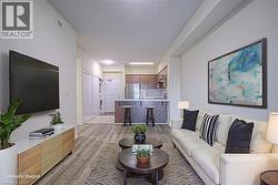 Living room with light wood-style flooring and a textured ceiling - 