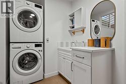 STACKING WASHER AND DRYER PLUS A WASH UP SINK FOR IMMEDIATE ACCESS FROM THE GARAGE - 