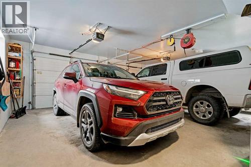 OVERSIZED HEATED GARAGE - 24 X 24 - HEATED FLOORS AND A 220V OUTLET - 140 Allen Crescent, Vulcan, AB - Indoor Photo Showing Garage