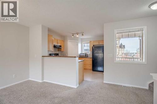 raised  breakfast bar - 122 Panamount Drive Nw, Calgary, AB - Indoor Photo Showing Kitchen
