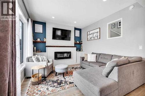 85 Reynolds Road, Sylvan Lake, AB - Indoor Photo Showing Living Room With Fireplace