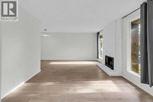 10 Radcliffe Crescent Se, Calgary, AB - Indoor Photo Showing Other Room With Fireplace