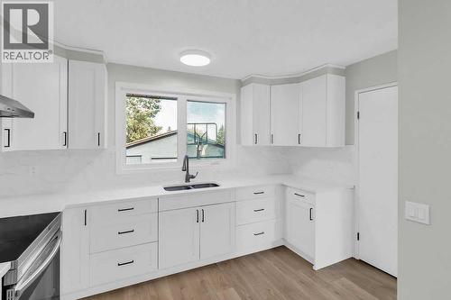 10 Radcliffe Crescent Se, Calgary, AB - Indoor Photo Showing Kitchen With Double Sink