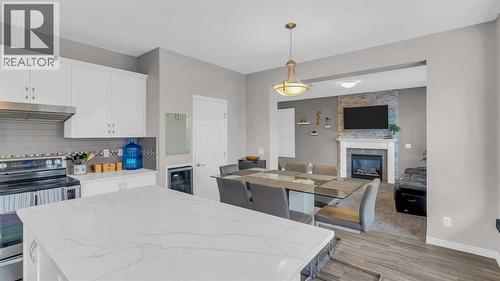 1120 Windhaven Close Sw, Airdrie, AB - Indoor Photo Showing Kitchen With Fireplace With Stainless Steel Kitchen