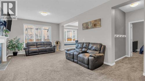 1120 Windhaven Close Sw, Airdrie, AB - Indoor Photo Showing Living Room With Fireplace