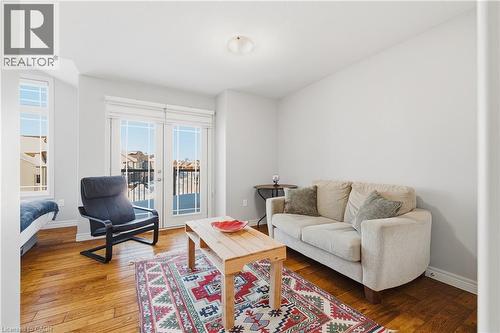 Living area with wood-type flooring and baseboards - 23 Doon Creek Street, Kitchener, ON - Indoor Photo Showing Living Room