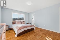 Bedroom with light wood finished floors and ensuite bath - 