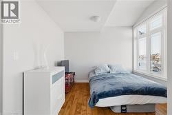 Bedroom with hardwood / wood-style flooring - 