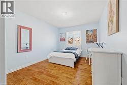 Bedroom featuring baseboards and light wood-type flooring - 
