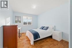 Bedroom with light wood-style floors and baseboards - 