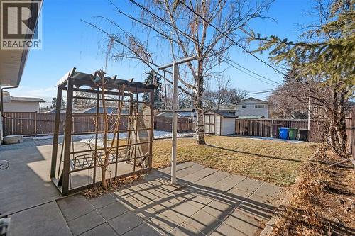 Small Pergola with Swing to enjoy the beautiful backyard. Functioning Clothesline - 1423 18A Street Ne, Calgary, AB - Outdoor