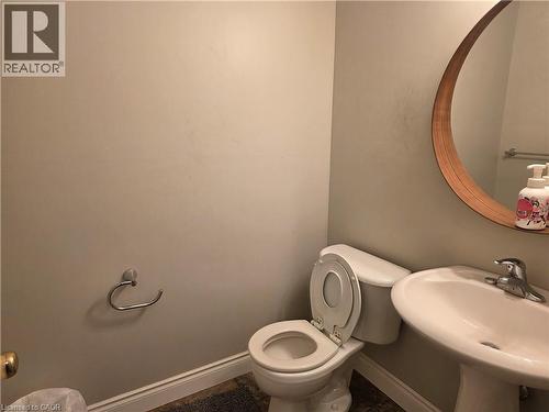 Half bath with toilet and baseboards - 220 Snowdrop Crescent, Kitchener, ON - Indoor Photo Showing Bathroom