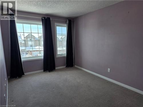 Spare room with a textured ceiling and carpet - 220 Snowdrop Crescent, Kitchener, ON - Indoor Photo Showing Other Room