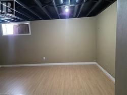 Below grade area featuring light wood-style floors and baseboards - 