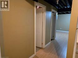 Corridor featuring baseboards and light wood-type flooring - 