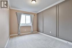 Empty room featuring ornamental molding, carpet, and a textured ceiling - 