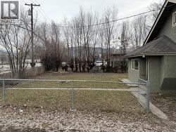 standing on the driveway looking north across the front yard. - 