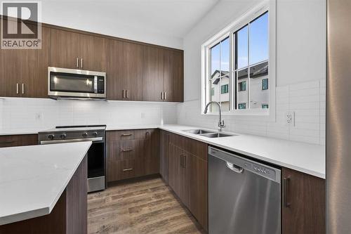 Kitchen - 64 Creekside Drive Sw, Calgary, AB - Indoor Photo Showing Kitchen With Stainless Steel Kitchen With Double Sink With Upgraded Kitchen