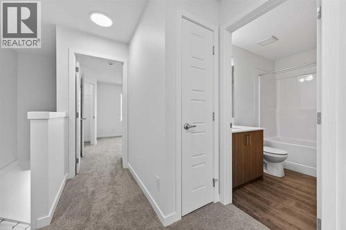 Upstairs hallway - 64 Creekside Drive Sw, Calgary, AB - Indoor Photo Showing Other Room