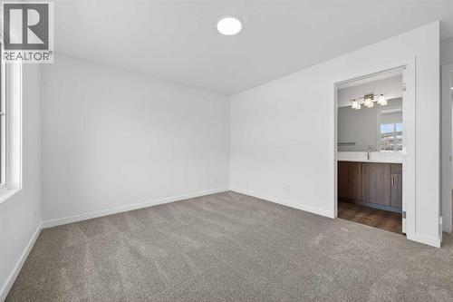 Primary bedroom - 64 Creekside Drive Sw, Calgary, AB - Indoor Photo Showing Other Room