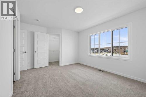 Primary bedroom - 64 Creekside Drive Sw, Calgary, AB - Indoor Photo Showing Other Room