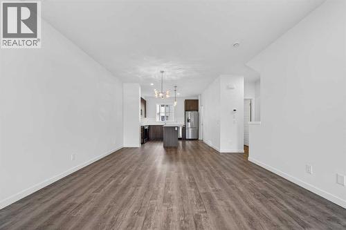 Open through living area/kitchen - 64 Creekside Drive Sw, Calgary, AB - Indoor