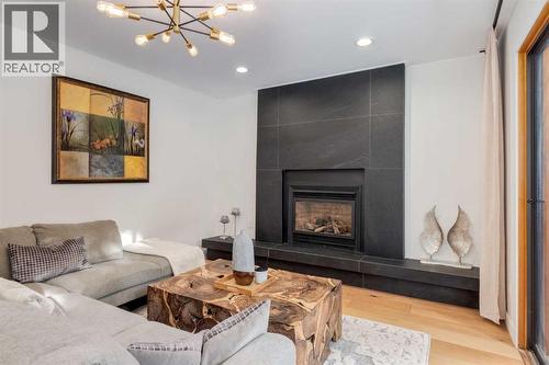 113 Straddock Terrace Sw, Calgary, AB - Indoor Photo Showing Living Room With Fireplace