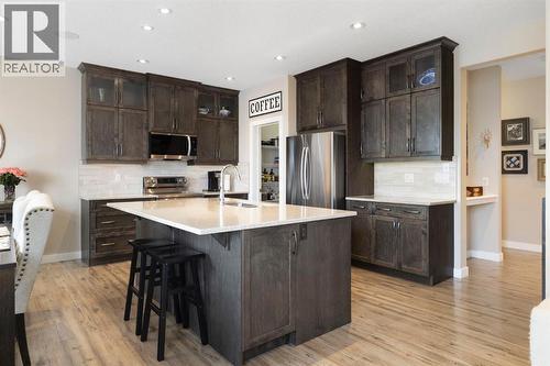 8 Emberside Glen, Cochrane, AB - Indoor Photo Showing Kitchen With Stainless Steel Kitchen With Upgraded Kitchen