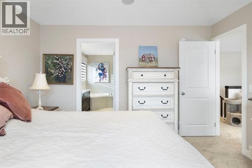 8 Emberside Glen, Cochrane, AB - Indoor Photo Showing Bedroom