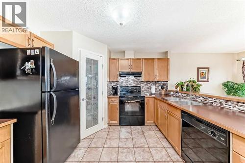 116 Hidden Creek Rise Nw, Calgary, AB - Indoor Photo Showing Kitchen With Double Sink