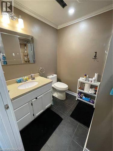Bathroom featuring crown molding, vanity, tile patterned floors, and recessed lighting - 18 Rosewell Street, Hamilton, ON - Indoor Photo Showing Bathroom