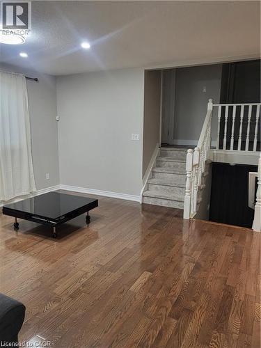 The dining area features hardwood floors and sleek pot lights, creating a warm yet modern atmosphere. Open to the kitchen, the space feels connected and inviting—perfect for both everyday meals and en - 18 Rosewell Street, Hamilton, ON - Indoor