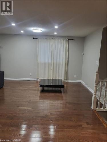 The dining area features hardwood floors and sleek pot lights, creating a warm yet modern atmosphere. Open to the kitchen, the space feels connected and inviting—perfect for both everyday meals and en - 18 Rosewell Street, Hamilton, ON - Indoor