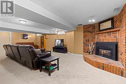 Lower level rec room with natural gas fireplace. - 