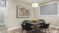 Dining space featuring baseboards and light wood-type flooring - 