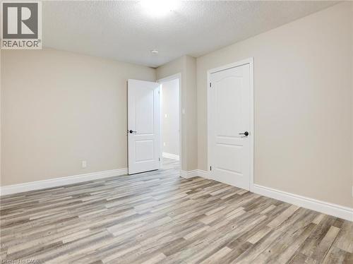 Empty room featuring a textured ceiling and light wood-style floors - 55 Silver Aspen Crescent, Kitchener, ON - Indoor Photo Showing Other Room