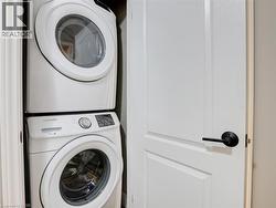Laundry area featuring stacked washer / drying machine - 