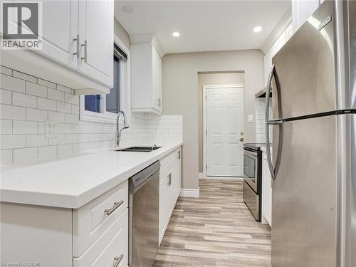 Kitchen featuring stainless steel appliances, white cabinetry, light stone countertops, light wood-style flooring, and recessed lighting - 55 Silver Aspen Crescent, Kitchener, ON - Indoor Photo Showing Kitchen With Stainless Steel Kitchen With Upgraded Kitchen