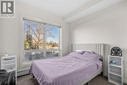 The spacious bedroom offers generous closet space and large windows - 