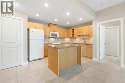 The kitchen offers granite countertops, a large centre island, and ample cabinet space—ideal for entertaining o - 