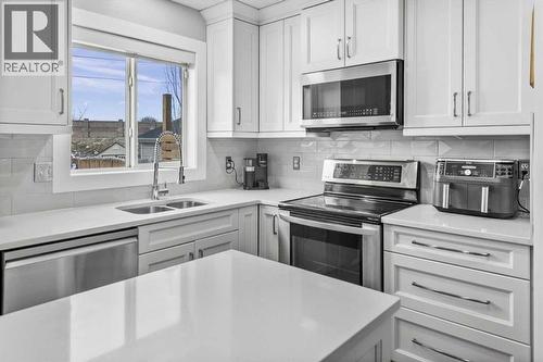39 Prestwick Heath Se, Calgary, AB - Indoor Photo Showing Kitchen With Double Sink