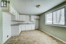 Kitchen with white cabinets and backsplash - 