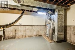 Below grade area featuring heating unit and water heater - 