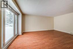 Spare room featuring light wood-style flooring and a textured ceiling - 