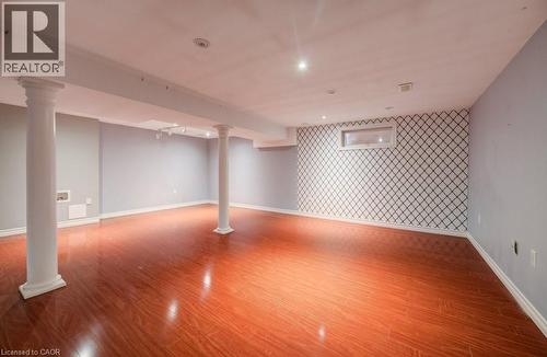 Below grade area with an accent wall, recessed lighting, wallpapered walls, and light wood-style flooring - 54 Nicklaus Drive, Hamilton, ON - Indoor Photo Showing Other Room