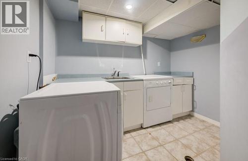 Washroom featuring a drop ceiling, cabinet space, and independent washer and dryer - 54 Nicklaus Drive, Hamilton, ON - Indoor Photo Showing Laundry Room