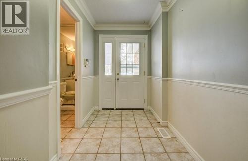 Entryway featuring ornamental molding and tile patterned floors - 54 Nicklaus Drive, Hamilton, ON - Indoor Photo Showing Other Room